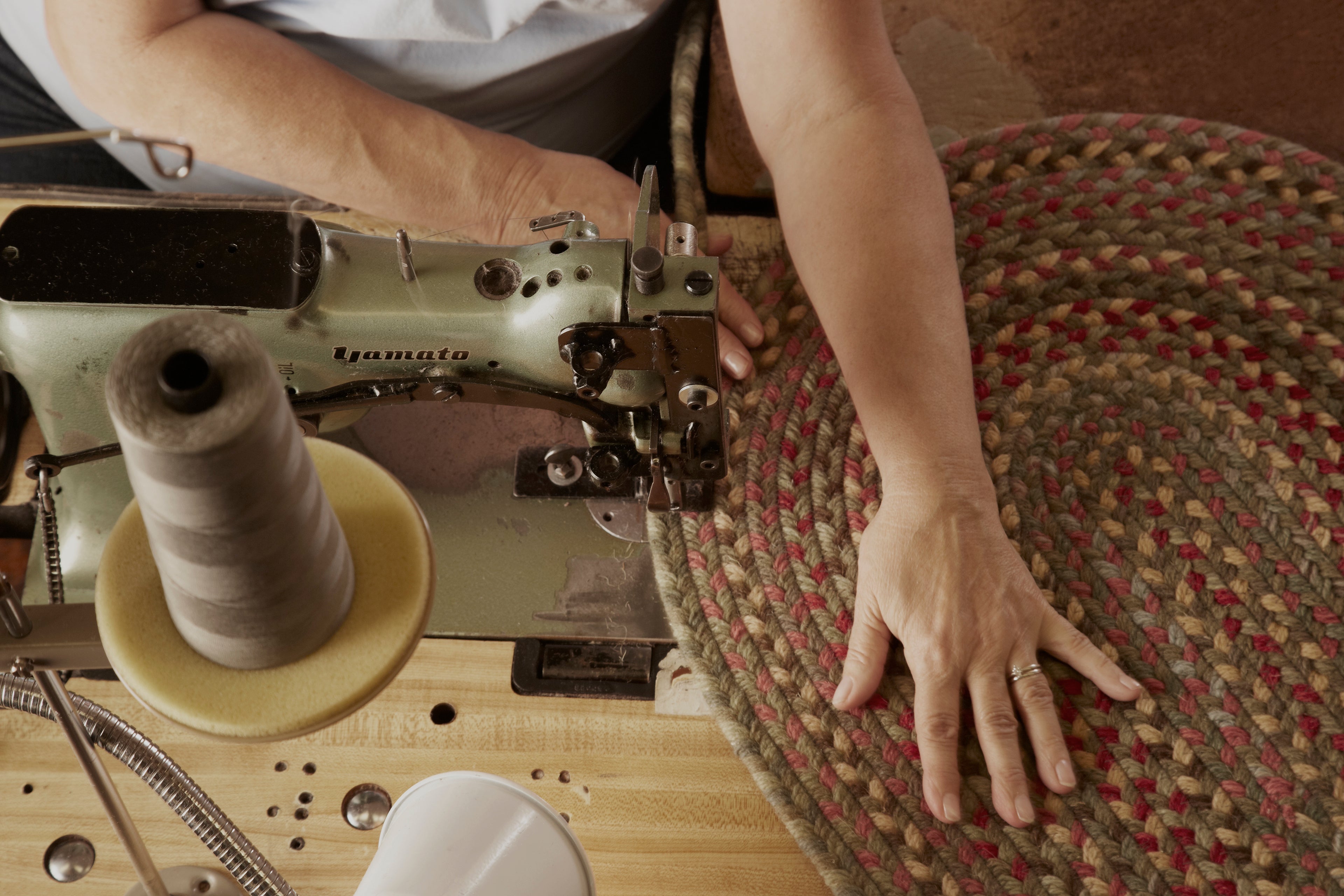 lady sewing and sewing machine and rug 