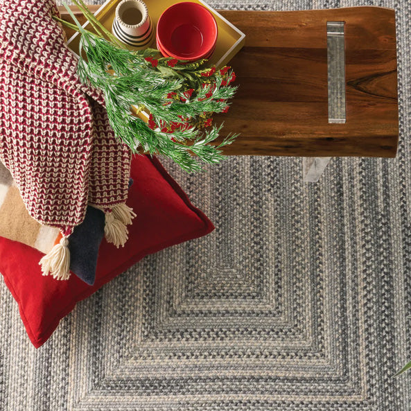 braided rug in a relaxed setting with a blanket and bench