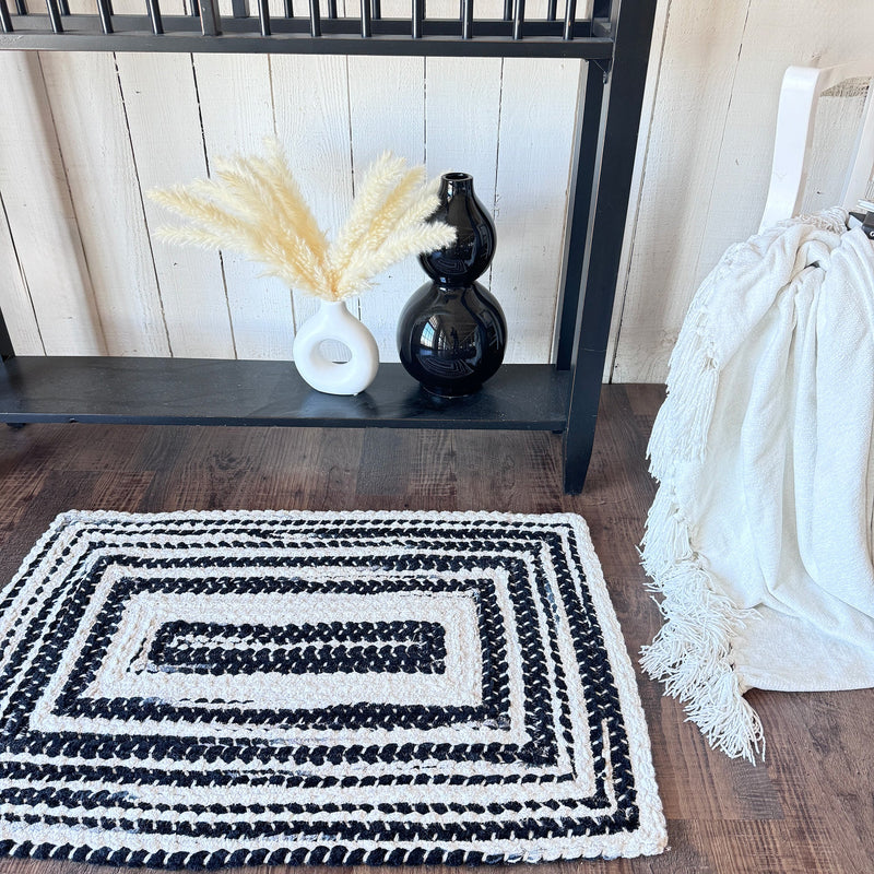 Crafted Black White Braided Rug Concentric Roomshot image