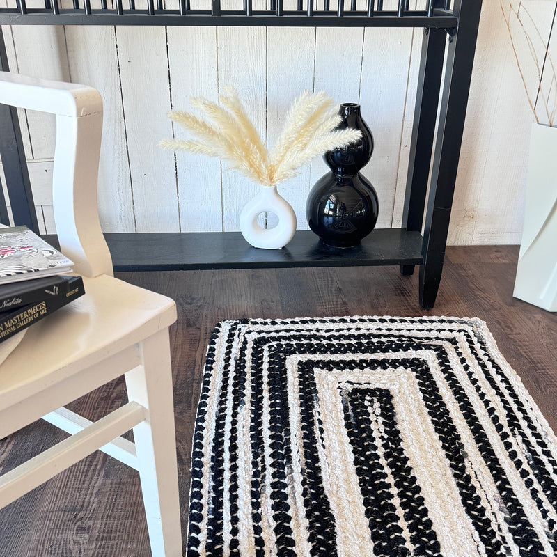 Crafted Black White Braided Rug Concentric Roomshot image